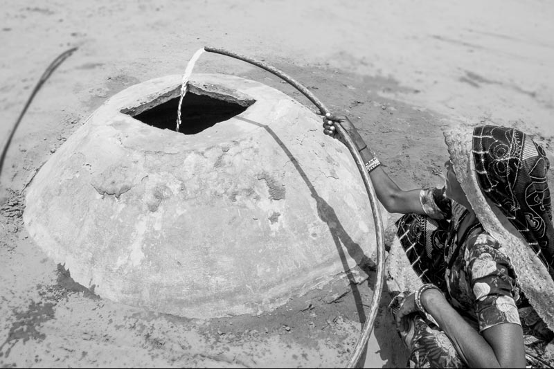 An underground storage tank called kundi in the courtyard of a house. The tank is filled with either supply water or water brought from well or pond. Drinking water is drawn from it as and when required - Bikaner district, Rajasthan